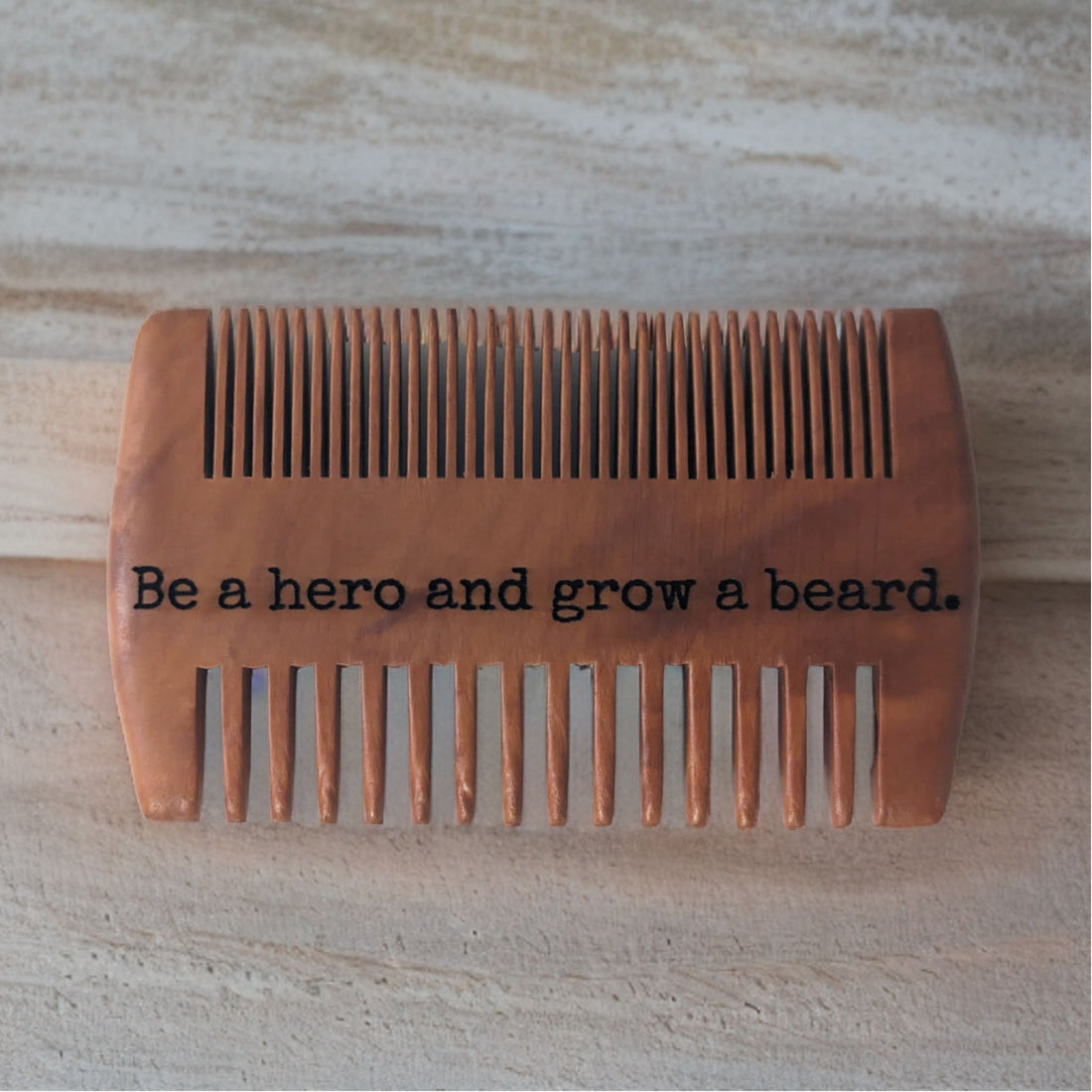 Two-sided beard comb with a laser-engraved message on the back
