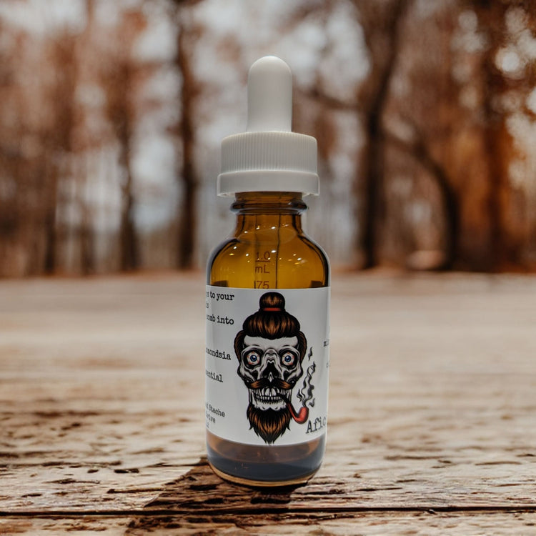 Aficionado beard oil in an amber dropper bottle on a wooden surface
